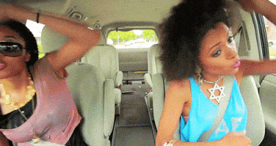 Girl dancing in the car celebrating is Friday